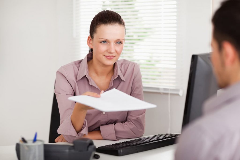 a woman handing a document